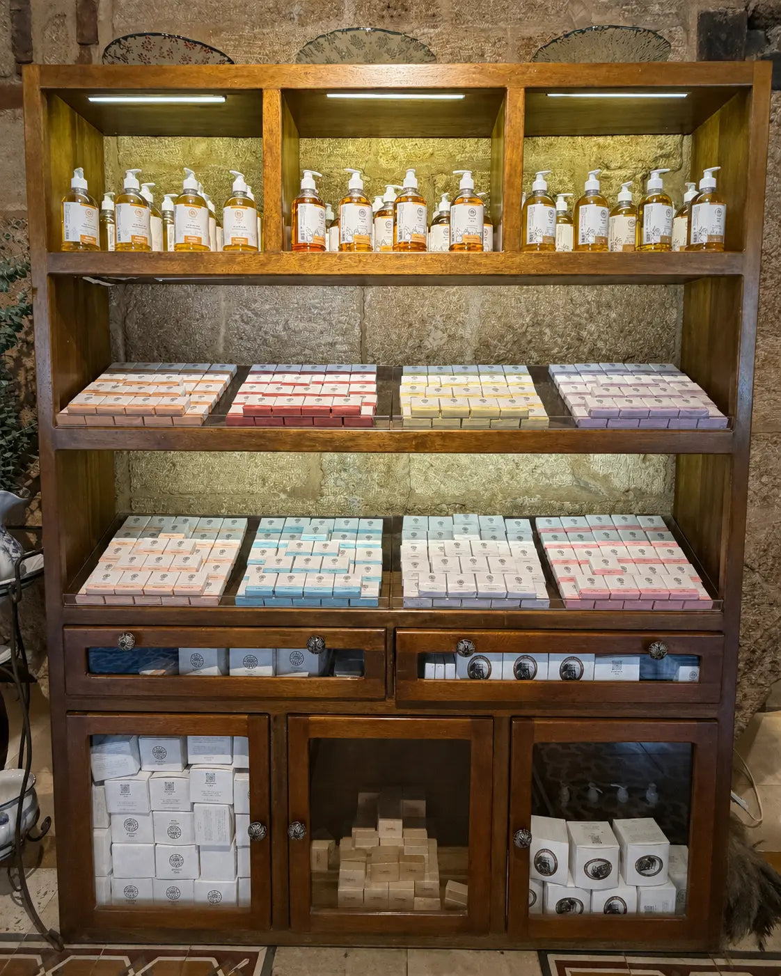 Masbanat Awaida soaps and liquid soaps displayed on the workshop shelf